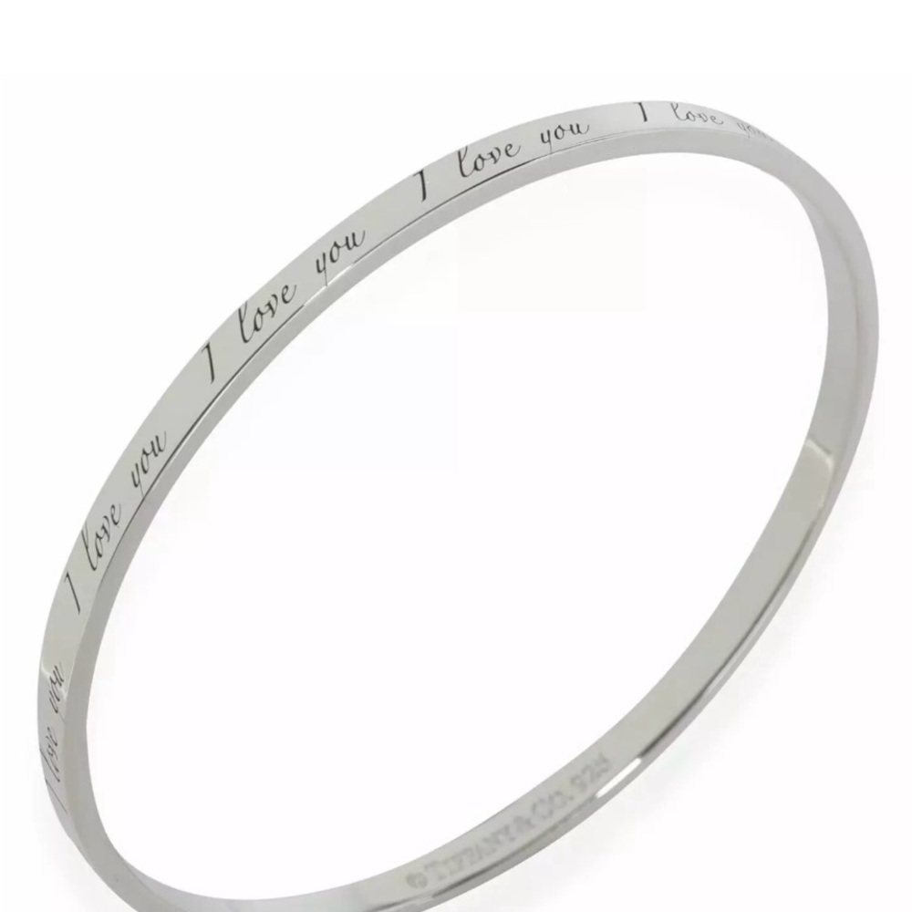 An authentic Tiffany & Co. sterling silver I LOVE YOU
Notes band bangle bracelet